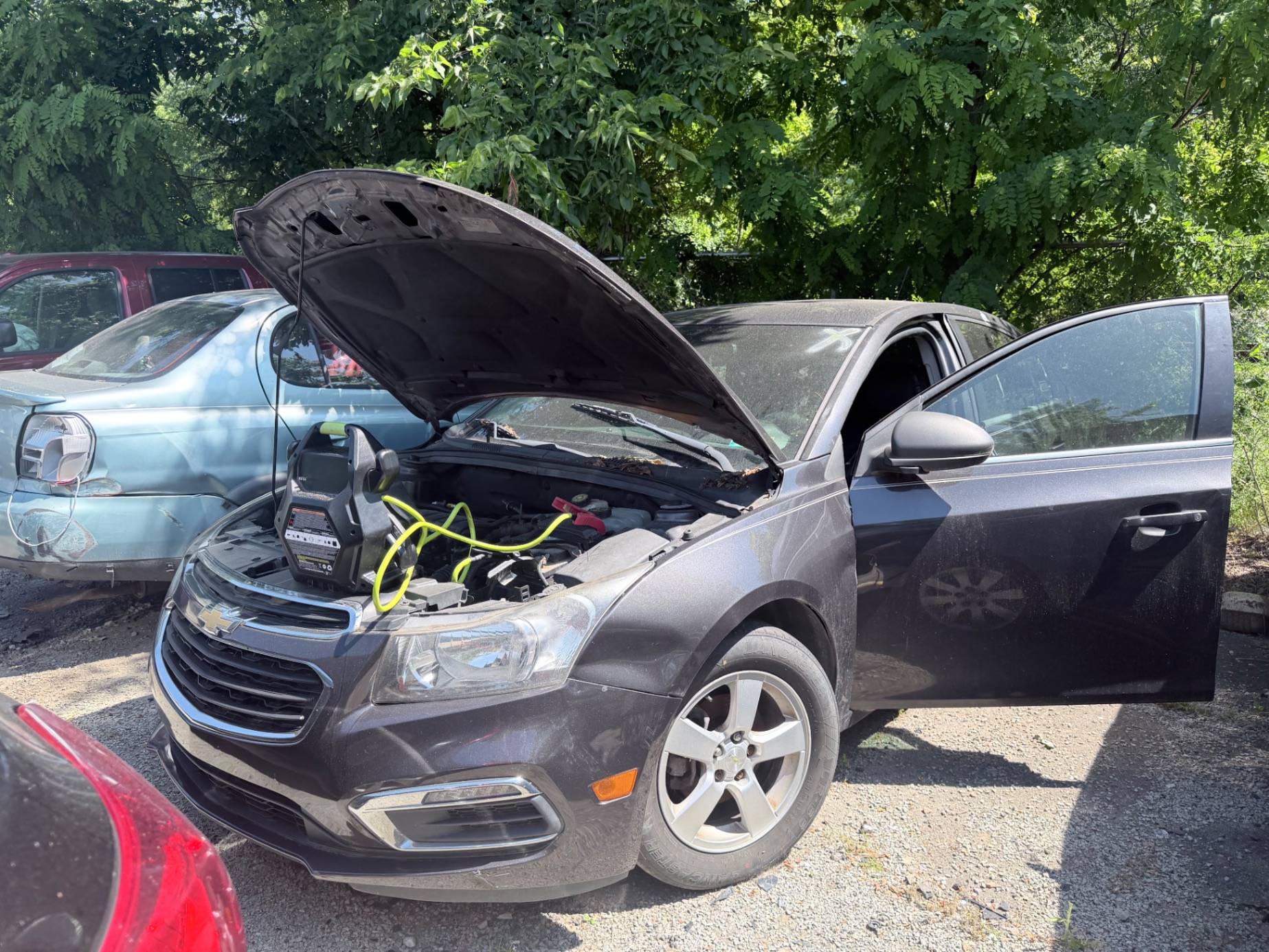 Chevy Cruze with hood open and diagnostic equipment connected